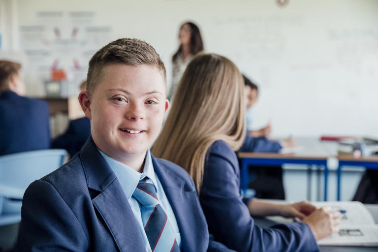 Down Syndrome school boy in a classroom